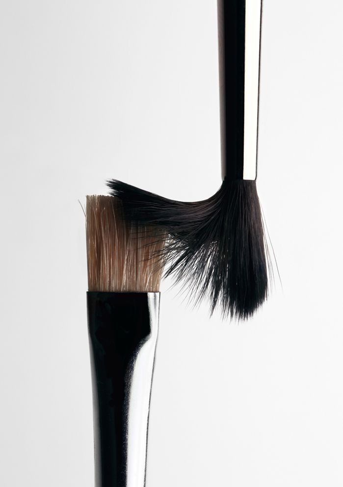 Two makeup brushes meeting